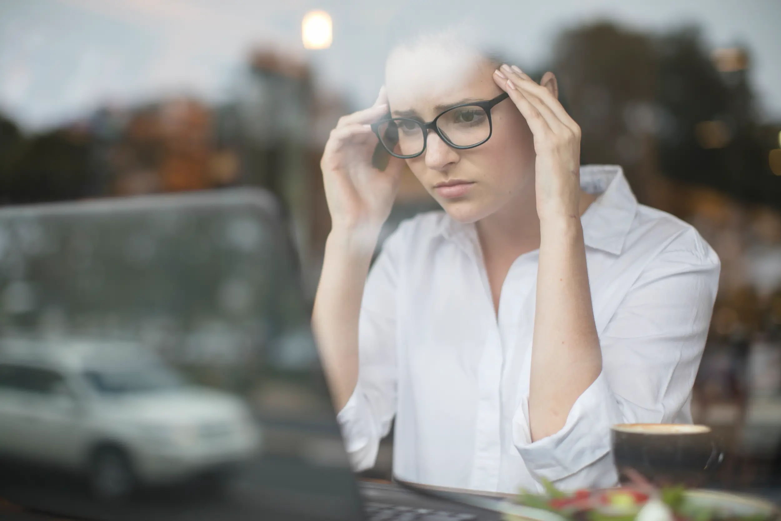 woman using laptop looking stressed
